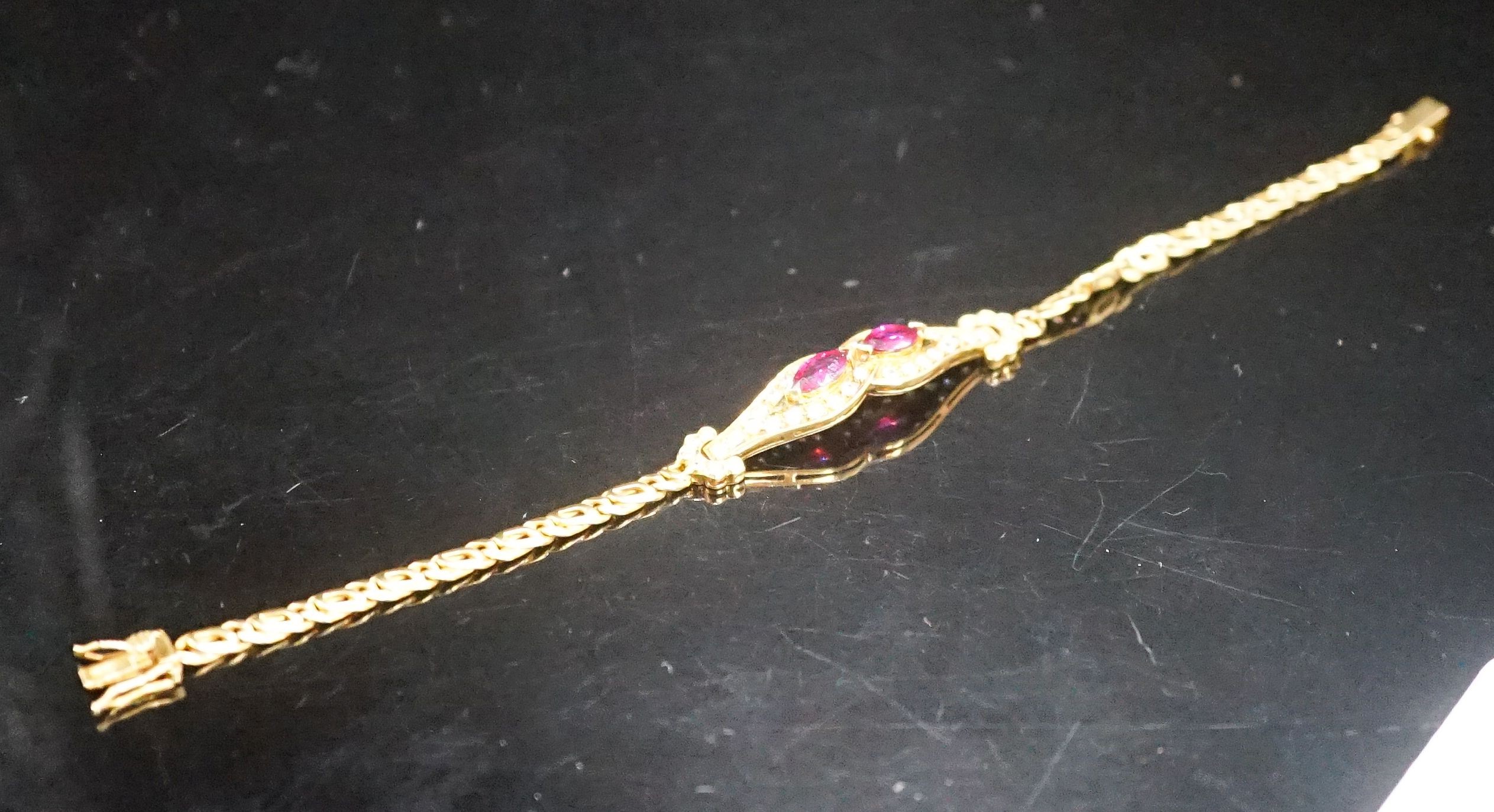 A lady's modern 18k, ruby and diamond set bracelet, 16cm, gross weight 9.2 grams.